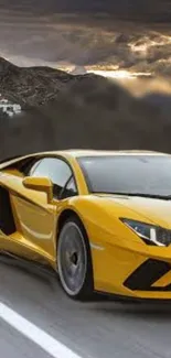 Yellow sports car on a scenic road with mountains in the background.