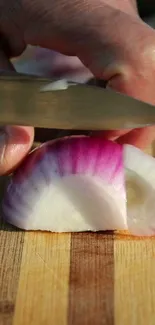 Close-up of a sliced onion on a wooden board, vibrant purple and white layers.