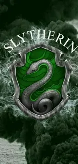 Slytherin crest with green snake on a dark smoky background.