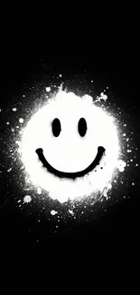 Grunge smiley face with paint splatter on black background.