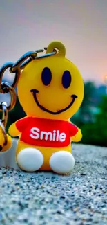 Cheerful smiley face keychain wallpaper on a sunny day.