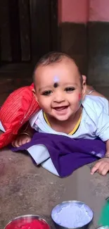 Smiling baby with colorful backdrop, joyful and playful.