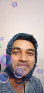 Smiling person surrounded by colorful floating bubbles.