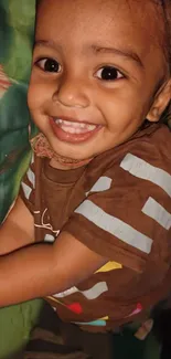 Smiling child in a brown shirt, close-up.