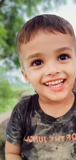 Smiling child with a nature background.