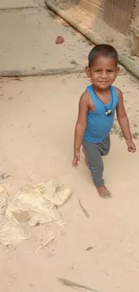 Smiling child walking on a sandy path in nature.