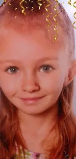 Smiling child with golden curls and light blue background.