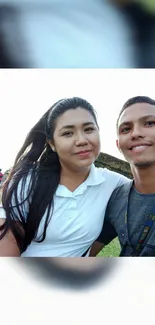 Smiling couple enjoying a sunny day outdoors.