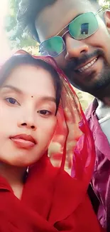 Smiling couple outdoor portrait in colorful attire.