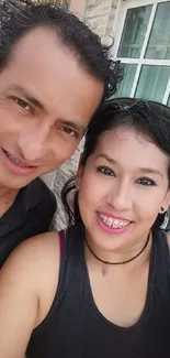 Smiling couple taking outdoor selfie, vibrant and cheerful.