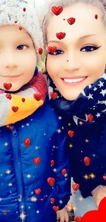 Smiling child and adult in winter gear with stars and heart.