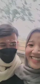 Friends smiling with a light gray city background, capturing a joyful moment.