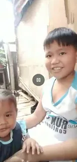 Smiling children sitting indoors, happy and joyful.