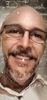 Smiling man with glasses and rustic brick background.