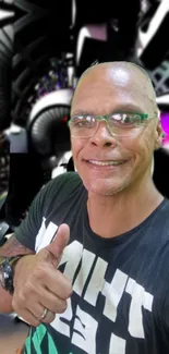 Smiling man in glasses with abstract black background.