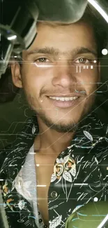 Smiling man illuminated by a ring light, wearing a floral shirt in a cozy setting.