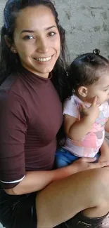 Woman smiling while holding a baby.