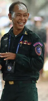 Smiling police officer in uniform with open smile outdoors.