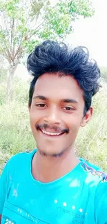 Smiling person outdoors with blue sky.