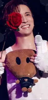 Smiling person holding a rose and plush toy on stage.