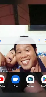 Smiling selfie on mobile wallpaper featuring a joyful moment.