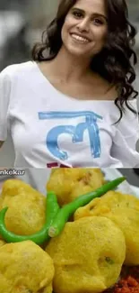 Smiling woman with plate of Indian snacks and green chilies.