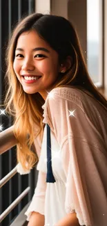 A smiling woman leans on a window ledge, bathed in soft, natural light.