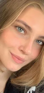 Woman taking a selfie in a car with a warm smile and natural lighting.