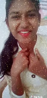 Smiling woman with glitter effect wallpaper for phones.