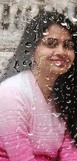 Smiling woman in pink shirt with stone carving backdrop