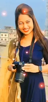 Smiling woman with a camera on a city rooftop background.