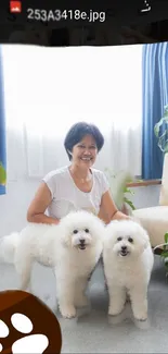 Woman smiling with fluffy white dogs in bright room.