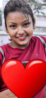 Mobile wallpaper with smiling woman and large red heart.