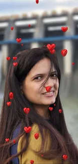 Smiling woman with red heart overlay on a blurred background.