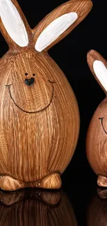 Two smiling wooden bunny figures on a dark background.