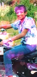 Boy joyfully riding a motorcycle in green setting.