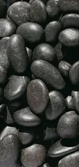 Smooth black stones mobile phone wallpaper, offering a calming and natural look.