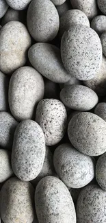 Arrangement of smooth gray stones for mobile wallpaper.