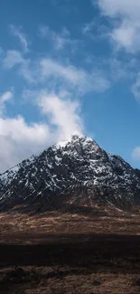 Snow-capped mountain under a blue sky.