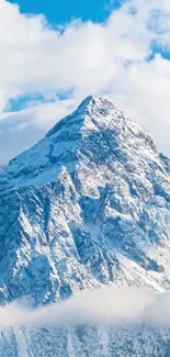 Majestic snow-covered mountain peak with bright blue sky.