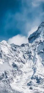 Snow-capped mountains under a blue sky wallpaper.