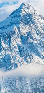 Snow-capped mountain with blue sky and clouds wallpaper.