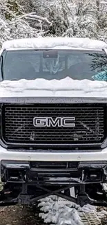 Snow-covered GMC truck in winter scene, mobile wallpaper.