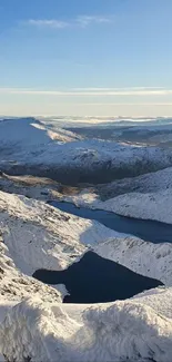 Snow-covered mountains under a clear blue sky.