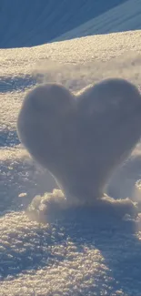 Heart-shaped snow sculpture in soft golden light on a serene winter day.