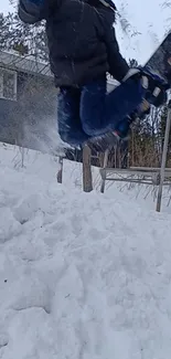 Snowboarder jumps in snowy landscape action shot.