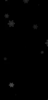 Black wallpaper with floating snowflakes.