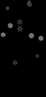 Minimalist black wallpaper with delicate white snowflakes on a dark canvas.