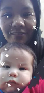 Mother and baby with snowflake overlay on mobile wallpaper.