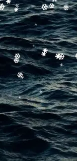 Dark ocean waves with drifting snowflakes, creating a peaceful winter scene.